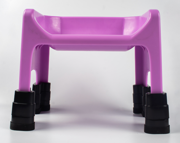 Purple plastic stool with black feet on a white background